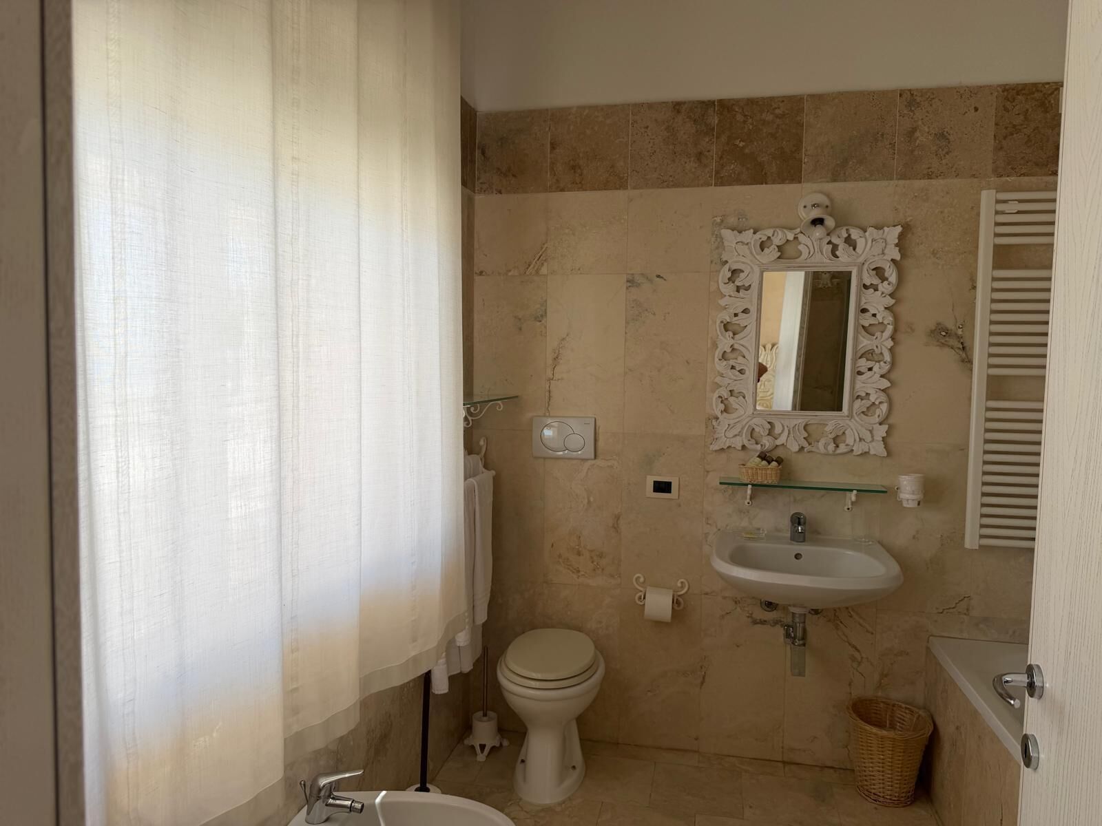 Une salle de bain avec des toilettes, un lavabo et un miroir.