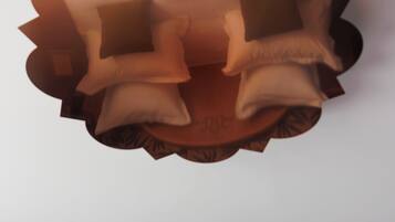 A ceiling with a decorative, cloud-like design.