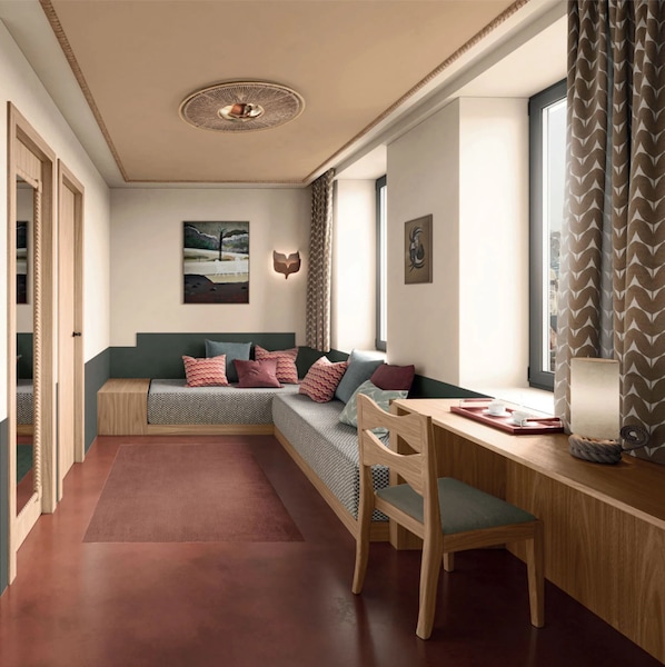 A cozy room with a built-in bench and a desk, a ceiling light fixture, and artwork on the walls. - Babel Lille (Lille)