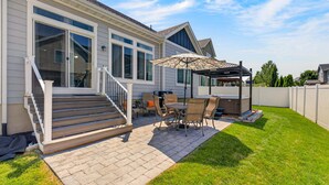 A residential house with a patio, outdoor furniture, and a covered seating area. - Heber Valley Escape w/ Games, Theater & Hot Tub (Heber City)