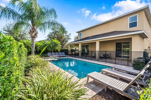 A modern house with a swimming pool, lounge chairs, and a patio area. - Foosball, Ping Pong, Resort-style Pool: Sweet Spot (Kissimmee)