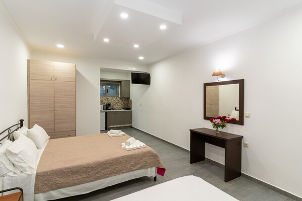 A bedroom with a bed, bedside table, and a mirror. - Beach House Apartment By The Sea 1 – Sea View, Wi-Fi & Air Conditioning (Zakynthos)