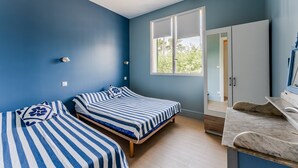 A room with two beds, a window, a door, and a marble countertop. - Holiday Home 'Villa au calme' with Private Terrace, Wi-Fi and Air Conditioning (Mimizan)