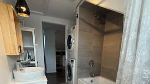 A modern bathroom with a toilet, sink, and shower.