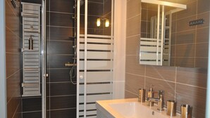 A modern bathroom with a glass shower enclosure, a large sink with multiple faucets, and a mirror above the sink. - Farmhouse in  French countryside, long stays only, 1 hour 15 minutes from Paris (chateau landon)