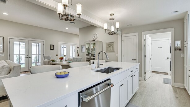 A modern kitchen with a central island, built-in appliances, and pendant lighting. - Beautiful Garden Villa With Golf Cart Option (Wildwood)