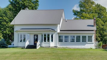 A two-story house with a front porch and a garage.