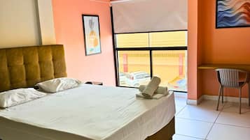 Desk, laptop workspace, blackout drapes, iron/ironing board