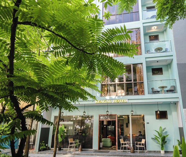 A hotel with a modern facade, a visible entrance, and outdoor seating area. - Reagal garden (Hulhumale)
