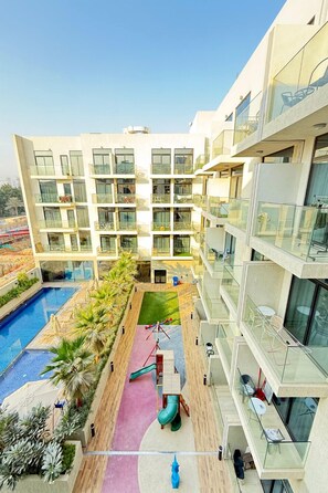Outdoor pool - Stylish Studio Pool View JVC Elysee 3 (Dubai)