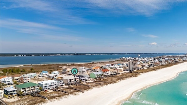 A coastal town with beachfront properties, a lighthouse, and a clear view of the ocean. - Seven Sandcastles 4 Bedroom Townhouse (Navarre)