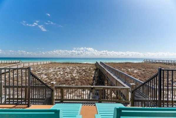 A beach view with wooden walkways and a sandy beach. - Seven Sandcastles 4 Bedroom Townhouse (Navarre)