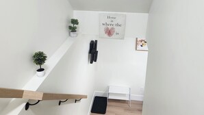 A staircase with wooden steps leading to a landing. - Beautiful Oasis Haven 1 Bedroom unit (Moncton)