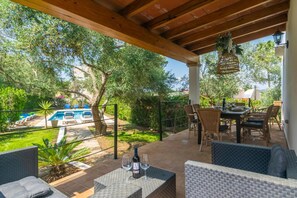An outdoor patio with a pool, dining area, and lounge seating. - Villa 'Blanca' with Private Pool, Wi-Fi and Air Conditioning (Felanitx)