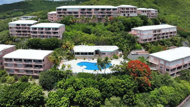 A resort with multiple buildings, a central pool, and lush greenery. - Crucian Sunsets-Amazing sea views, pool, generator, 3bd/2ba Coakley Bay Condo. (Christiansted)