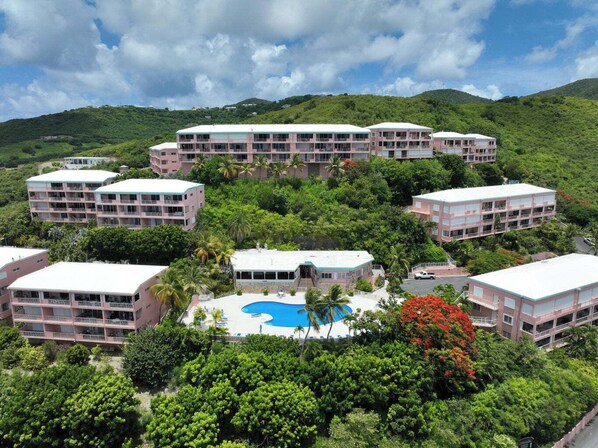A resort with multiple buildings, a central pool, and lush greenery. - Crucian Sunsets-Amazing sea views, resort pool, 3bd/2ba Coakley Bay Condo. (Christiansted)