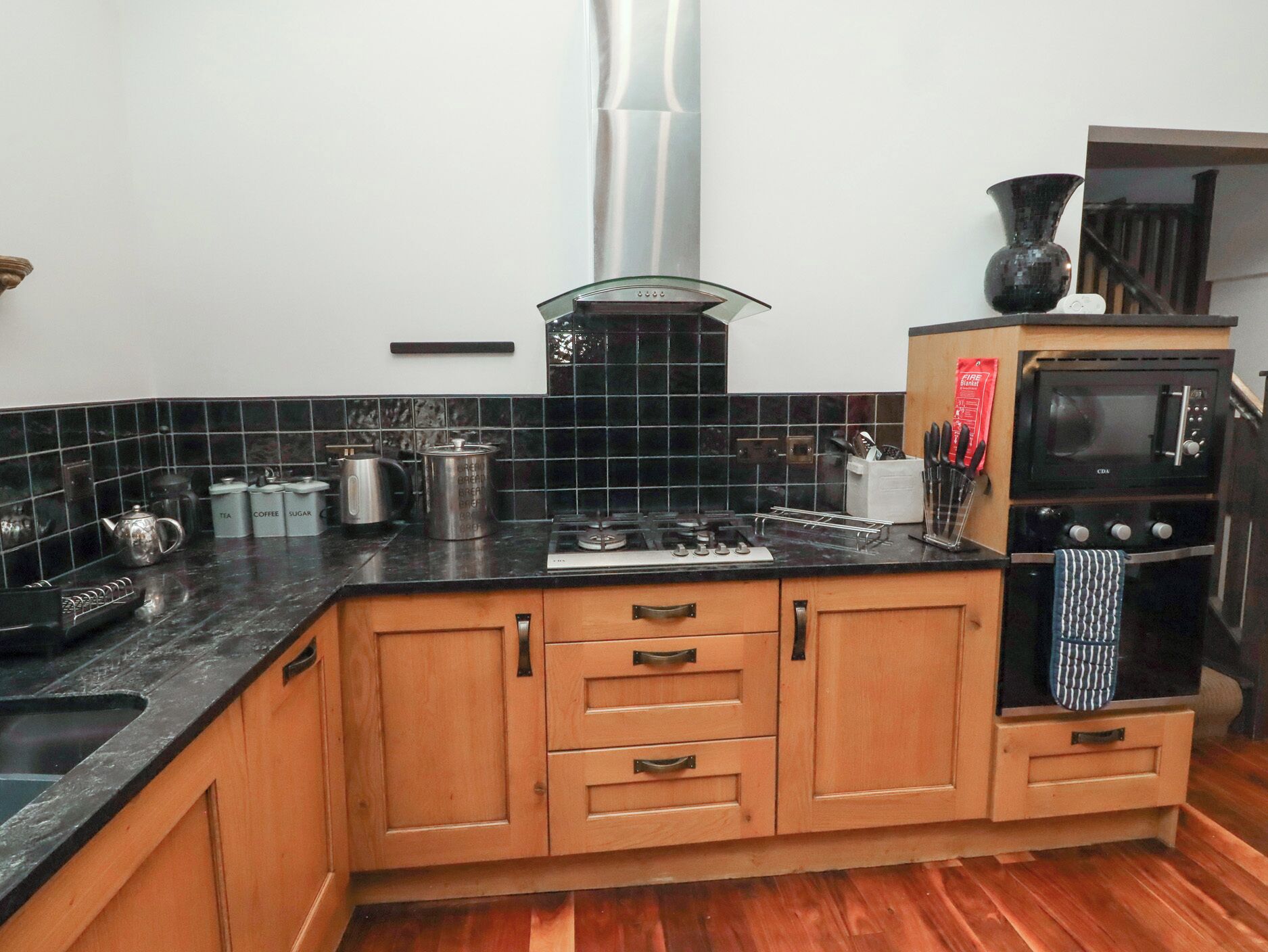 A kitchen with a stove, microwave, and cabinets.