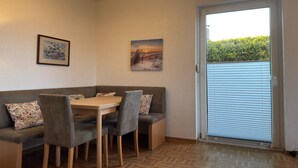 Un comedor con una mesa, sillas y un banco.