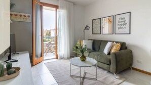 A modern living room with a green sofa, a round coffee table, and a sliding glass door leading to a balcony. - ChatGPT ha detto:The SpaceWelcome to your corner of tranquility at the gateway to Venice!This cozy apartment in Mestre is the ideal solution for those who want to enjoy Venice stress-free, thanks to its strategic location in a quiet, safe, and well-serve (Venice)