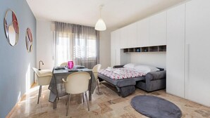 A compact bedroom with a bed, bedside tables, a desk with chairs, and a window with curtains. - The SpaceLooking for a comfortable, stylish, and strategically located stay to explore Venice and beyond? This newly renovated home in Mestre is the ideal solution for families, small groups, and travelers seeking both comfort and convenience.Just steps  (Venezia)