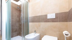 A bathroom with a glass-enclosed shower, a bidet, and a toilet. - The SpaceLooking for a comfortable, stylish, and strategically located stay to explore Venice and beyond? This newly renovated home in Mestre is the ideal solution for families, small groups, and travelers seeking both comfort and convenience.Just steps  (Venezia)