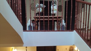 A multi-level interior with a wooden staircase, a black door, and a fireplace. - Casa palaciega Doña Leocadia (Viana)