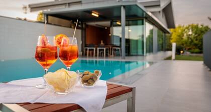 The SpaceThe villa offers three elegant bedrooms and spacious bathrooms. The master bedroom features a double bed, ensuite bathroom with both shower and bathtub, a walk-in closet, and a television. The second bedroom has a double bed and shares a corrido