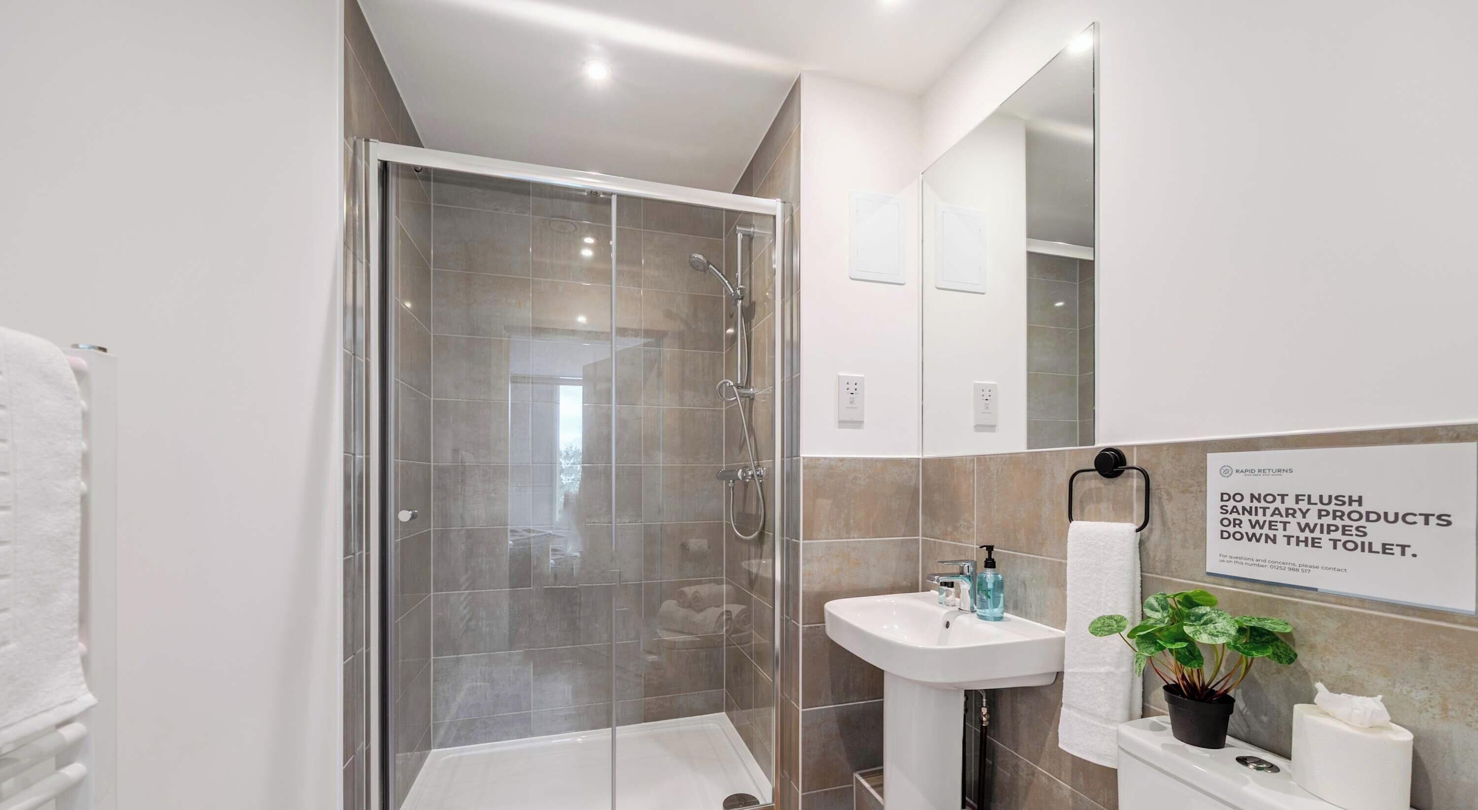 Shower, hair dryer, towels, shampoo