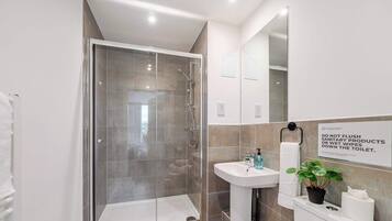 Shower, hair dryer, towels, shampoo