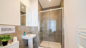Shower, hair dryer, towels, shampoo