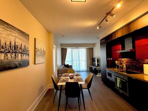 A modern hotel room with a dining area, a kitchen, and a living space. - Move in Ready RogersCenter CN Tower 2B2B City Lakeview &Free Parking (Toronto)