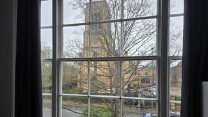 A window with a view of a building and a street. - Apartment - Sleeps 6 & Near Station (Bedford)
