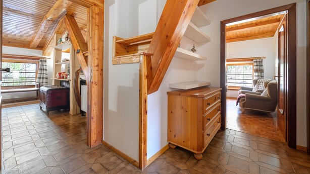 A spacious room with wooden beams, a sofa, a wooden cabinet, and a window with a view. - Holiday Home 'La Casa Di Nonno Giulio' with Mountain View and Wi-Fi (Roncone)