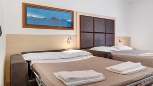 A hotel room with two beds, a headboard, a framed picture on the wall, and a bedside table. - Room 'Camera Matrimoniale' with Mountain View, Wi-Fi and Air Conditioning (Mori)