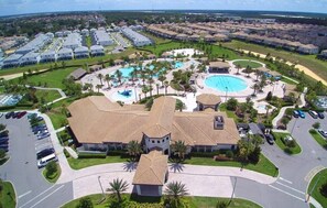 A resort with multiple swimming pools, a central building, and a parking area. - ChampionsGate 4BR w/ Pool – Near Disney (Davenport)