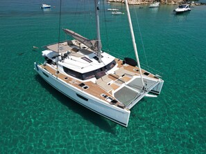 A large yacht with multiple decks, a covered seating area, and a sail. - 
NEW LISTING Welcome aboard our luxurious 50' Fountaine Pajot Saba 50 Catamaran (Key West)