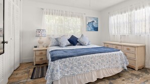 A bedroom with a bed, a nightstand, a dresser, and a ceiling fan. - Pompano 3225 20A (Pompano Beach)