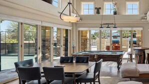 A spacious indoor area with a pool table, dining table with chairs, and a pool. - Luxury Tennis Retreat & RV w/Hot Tub, Japanese deck, mini golf 15 min to Strip (Las Vegas)