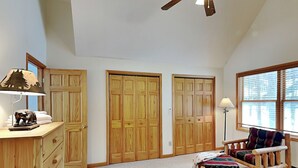 A spacious room with a large closet, a desk with a lamp, a chair, and a window with blinds. - Almost Heaven (Swanton)