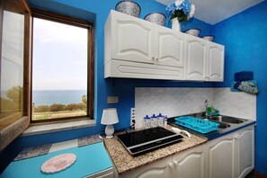 Private kitchen - L’Oasi nella Natura is an independent house with large private outdoor spaces and a 180-degree panoramic view of the Mediterranean Sea and the Aeolian Islands.The house consists of two air-conditioned double bedrooms, a living and dining area, a fully  (Caronia)