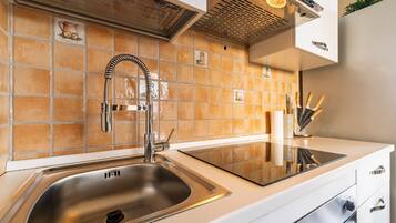 Een koelkast, een oven, een kookplaat, een koffiezetapparaat/waterkoker