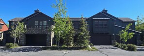 A two-story house with a stone facade, a garage, and a driveway. - Snowcreek Resort Vacation Rental 1513 (Mammoth Lakes)