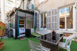 Una habitación compacta con una cama, una mesita y una silla.