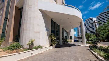 A modern building with a curved entrance, large windows, and a sign reading "Aquarius."