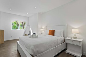 Bedroom 8 — Queen bed with barn door to closet and contrast dark-charcoal doors - Sherman Oaks 5BR | Valley Views + Fire Pit | C&C (Los Angeles)