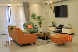 Apartment, 2 Bedrooms | Living area | 65-inch Smart TV with digital channels, DVD player, pay films - Masanyu Suites (Kampala)