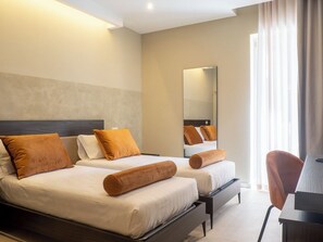 A hotel room with two beds, a large mirror, and a desk with a chair. - N42 Hotel (Naples)