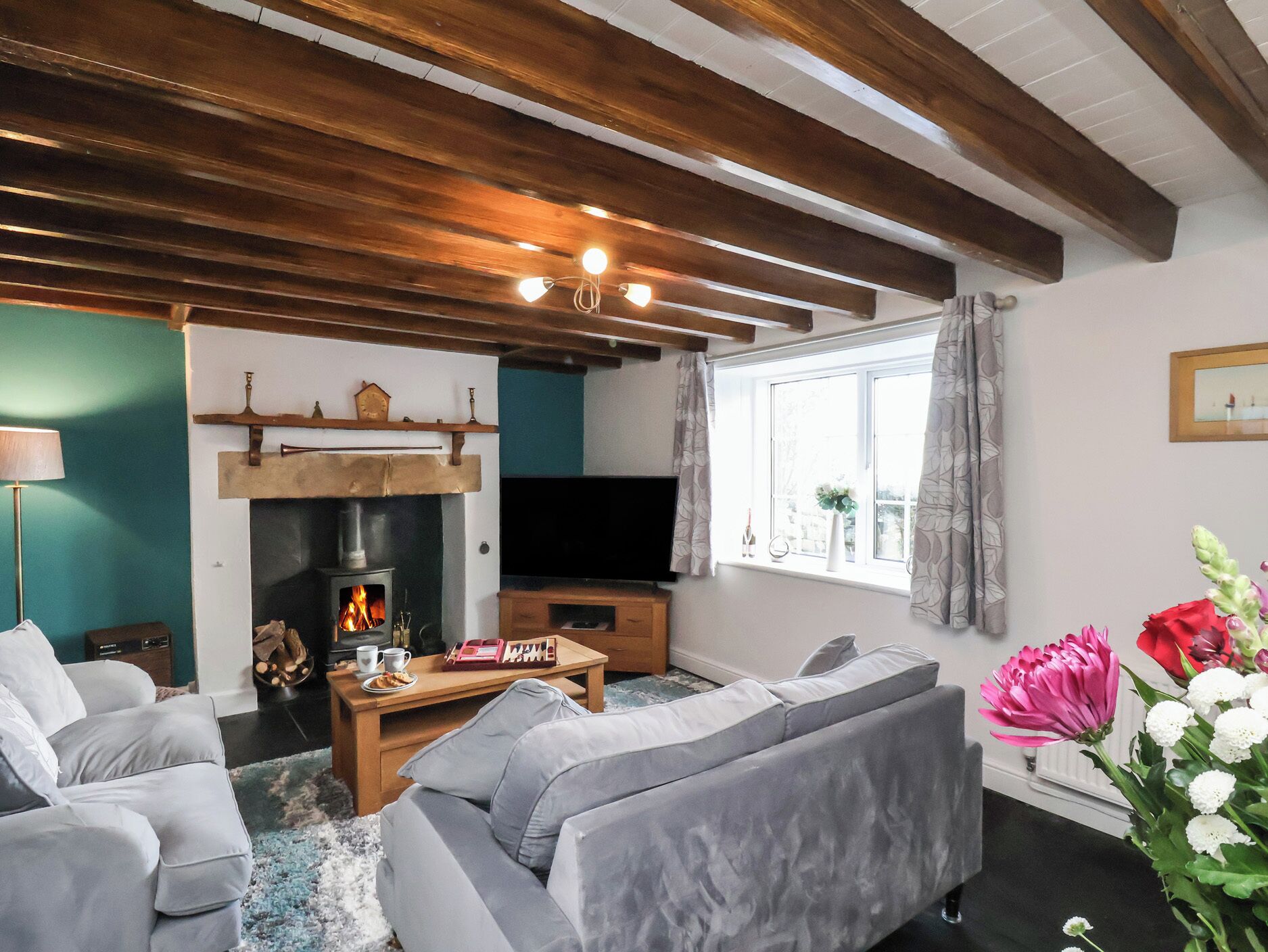 A living room with a fireplace, a television, a sofa, and a coffee table.