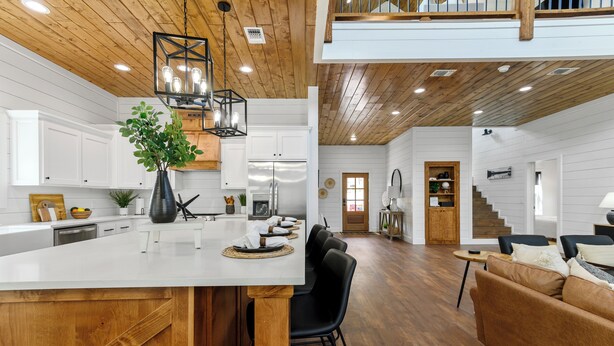 A spacious kitchen with white cabinetry, a large island, and a wooden ceiling. - Cozy Pines Cabin-Hot Tub + Fire Pit + Play set- Backyard (Broken Bow)