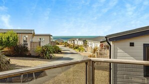 A row of beachside mobile homes with a clear view of the ocean. - Laburnum, Tresaith - Two Bedroom Cottage, Sleeps 4 (Tresaith)